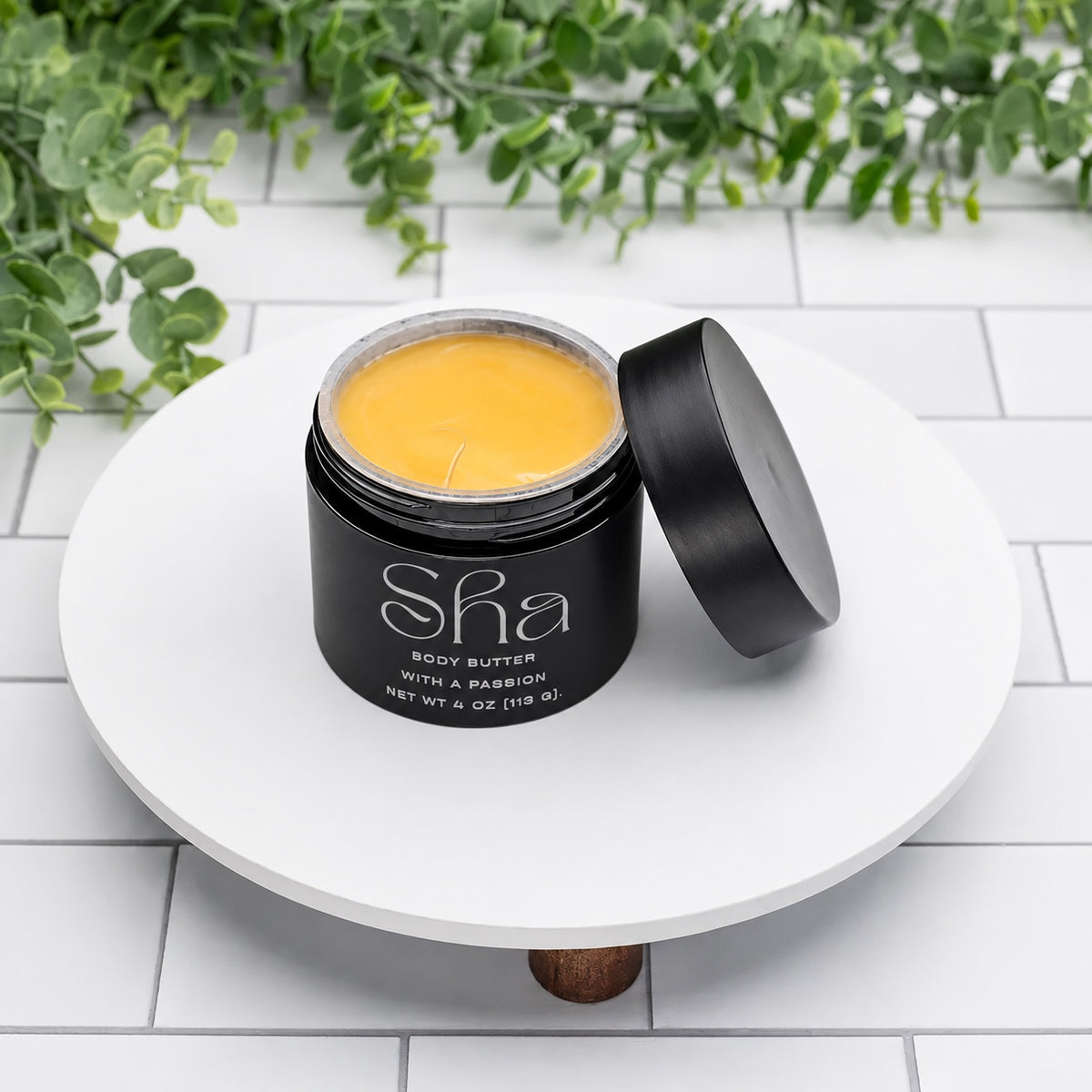 SHA With a Passion body butter in a black 4 oz jar